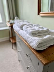 a bathroom with a wooden counter with towels on it at The Old Bakehouse in Colyton