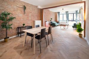 a dining room and living room with a brick wall at Charming and Spacious Apartments in the Heart of Antwerp in Antwerp