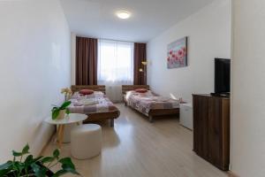 Postel nebo postele na pokoji v ubytování Agro Complex Apartments