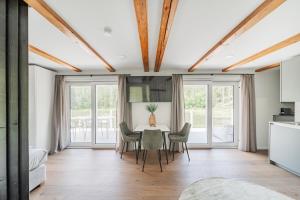 a kitchen and dining room with a table and chairs at Das Haidensee in Glanegg
