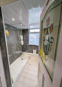 a large bathroom with a shower and a toilet at The George Guest House in Plymouth