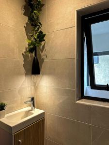 a bathroom with a sink and a window at Klik Klak Appart Hotel in Cotonou