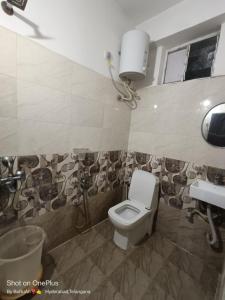 a bathroom with a toilet and a sink at WAY INN FAMILIAR in Hyderabad
