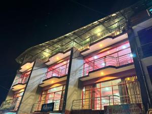 a building with colorful lights on it at night at SkyLark Guest House in Nawalapitiya