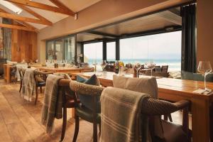 a dining room with a view of the ocean at Port William Inn in Tintagel