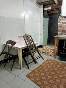 einen Tisch und zwei Stühle in einem Zimmer in der Unterkunft BUDJET HOMESTAY CAMERON HIGHLANDS in Tanah Rata