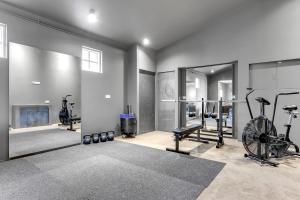 a gym with bikes and exercise equipment in a room at Himri the mountain villa in Mosfellsbær