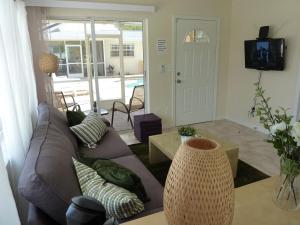 a living room with a couch and a tv at Beach Resort in Cape Coral in Cape Coral