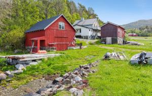 a couple of red barns in a field at 5 Bedroom Cozy Home In ydegard 