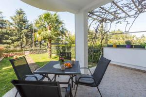 a patio with a table and chairs on a porch at Apartment in Porec/Istrien 10331 in Poreč