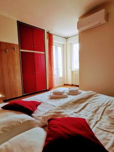 a bedroom with a large bed with red cabinets at Ristorante Le Rasole in Garda