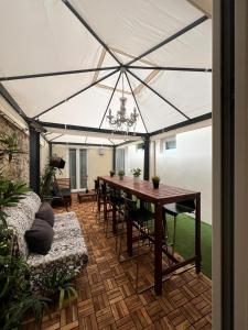 a patio with a table and chairs under a tent at NEW Ground Floor apt and PATIO in Florence