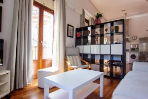sala de estar con mesa blanca y sofá en RentalSevilla en Plaza de los Terceros, en Sevilla