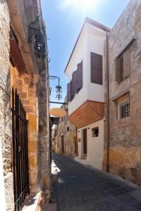 an alley in an old town with buildings at Rodos Old Town Aqua Luxury Suites in Rhodes Town