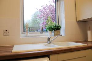 a kitchen counter with a sink and a window at Hidden Oxford Haven with Free Parking in Oxford