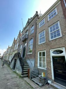 a large brick building with a stairway in front of it at Stadshotel Geertruidenberg in Geertruidenberg