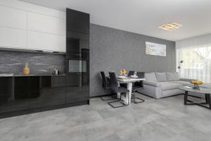 a living room with a couch and a table at Modern Apartment Close to the Beach in Gdańsk by Noclegi Renters in Gdańsk +12 photos