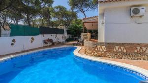 a swimming pool in front of a house at Casa La Marquesa Punta Umbria by Ruralidays in Punta Umbría