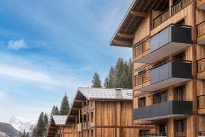 a building with balconies on the side of it at Les Chalets Laska in Les Contamines-Montjoie