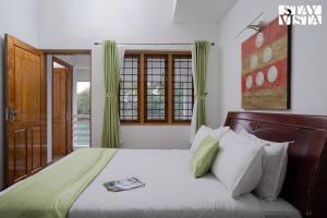 a bedroom with a large bed with green curtains at StayVista at Pine Escape - Breakfast Included in Pīrmed