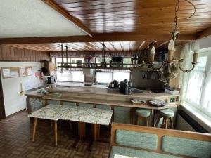 a kitchen with a counter and a table and chairs at Ferienhaus Dankl in Hollersbach in Hollersbach im Pinzgau