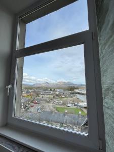 a window with a view of a city at Harbour & Mountain Views, Porthmadog House, Sleeps 9, 4 Bedrroms, 2.5 Bathrooms in Porthmadog