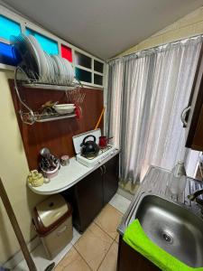 a small kitchen with a sink and a table at TJ+ Hostel in Batumi