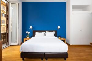ローマにあるSky Blue Place Romeの青い壁のベッドルーム1室(大型ベッド1台付)