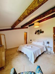 1 dormitorio con 1 cama blanca grande en una habitación en Mas du Rollier Chambres d'hôtes, en Eygalières