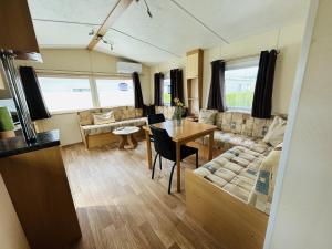 a living room with a couch and a table at NV 1162 - Beach Resort Nieuwvliet Bad in Nieuwvliet