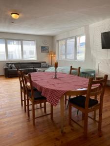 a dining room with a table and chairs and a couch at Green Mountain Retreat in Fliess