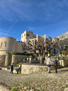 a group of people standing in front of a castle at Villa Mefaja in Krujë