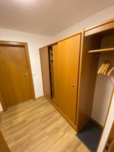 a room with wooden cabinets and a closet at Hotel Faller in Breitnau