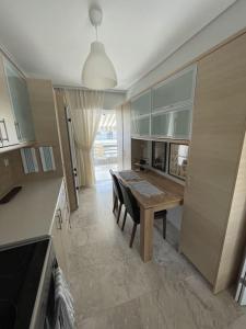 a kitchen with a table and a dining room at Alexandra's View in Piraeus