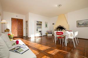 a living room with a table and a fireplace at Balcone Panoramico sul Garda in Tremosine Sul Garda