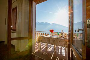 a balcony with a table with a view of the ocean at Balcone Panoramico sul Garda in Tremosine Sul Garda