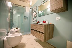 a bathroom with a toilet and a sink and a shower at Residenza Il Cavaliere del Lago - Happy Rentals in Riva del Garda