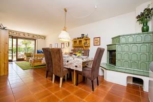 a dining room with a table with chairs and a fireplace at Residence Christina Due Laghi in Tenno