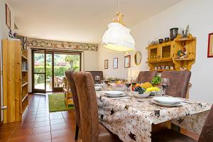 a dining room with a table and chairs at Residence Christina Due Laghi in Tenno