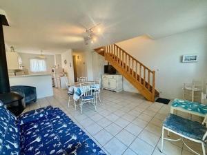 a living room with a staircase and a table and chairs at Quiberon - Maison 3 pièces - 6 pers - Calme avec parking - FR-1-478-61 in Quiberon