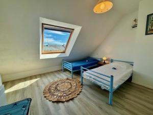 a attic room with two beds and a window at Quiberon - Maison 3 pièces - 6 pers - Calme avec parking - FR-1-478-61 in Quiberon +4 photos