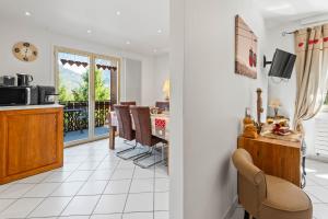 a living room with a kitchen and a dining room at Smartstay au reve Savoyard 5 in Morillon