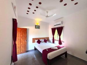 a hotel room with a bed and a window at De Capital Hotel with Swimming Pool in Puducherry