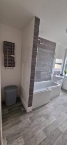 a large bathroom with a tub and a shower at LFC Anfield Guest House in Liverpool +15 photos
