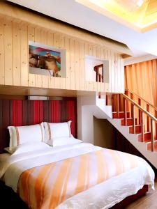 a bedroom with a large bed and a staircase at Family Hotel Zhangjiajie in Zhangjiajie