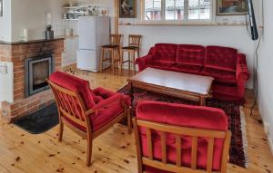 a living room with a couch and a table and chairs at 3 Bedroom Pet Friendly Home In Källby in Källby