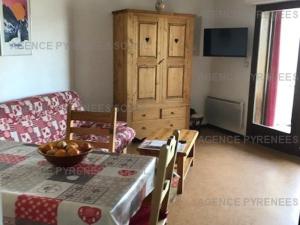 a living room with a table and a chair at Appartement Les Angles, 2 pièces, 6 personnes - FR-1-295-141 in Les Angles