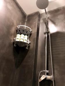 a bathroom with a rack of bottles in a shower at Family Hotel Zhangjiajie in Zhangjiajie