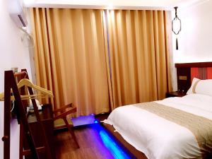 Postelja oz. postelje v sobi nastanitve Family Hotel Zhangjiajie