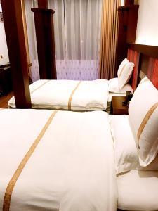 Postelja oz. postelje v sobi nastanitve Family Hotel Zhangjiajie